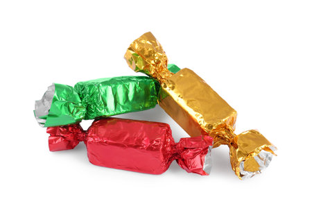 Tasty candies in colorful wrappers isolated on whiteの写真素材
