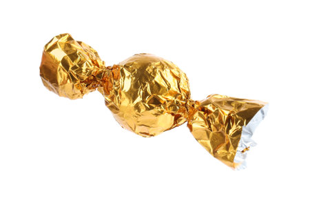 Tasty candy in yellow wrapper isolated on whiteの写真素材