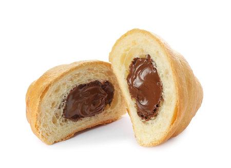 Delicious cut croissant with chocolate isolated on whiteの写真素材