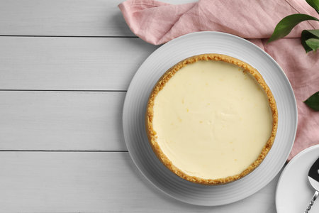 Tasty vegan tofu cheesecake on white wooden table, top view. Space for textの写真素材