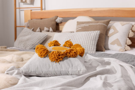 Large comfortable bed with soft pillows and blanket in room. Home textileの写真素材