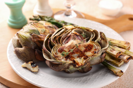 Tasty grilled artichokes on table, closeup viewの写真素材