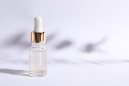 Bottle of cosmetic serum on white background. Space for textの写真素材