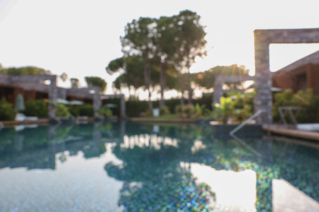 Outdoor swimming pool at resort, blurred viewの写真素材