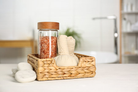 Composition with spa herbal bags on white wooden table in bathroom. Space for textの写真素材