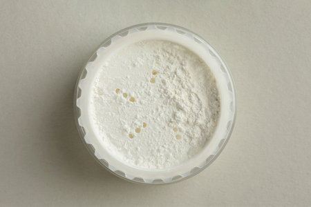 Rice loose face powder on light gray background, top view. Makeup productの写真素材