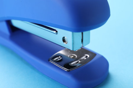 Bright stapler on light blue background, closeupの写真素材