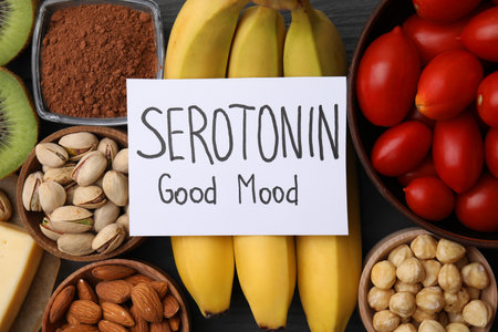 Many different products and card with the phrase Serotonin Good Mood on table, flat lay. Natural antidepressantsの写真素材
