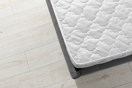 New light green mattress on gray bed indoors, top view. Space for textの写真素材