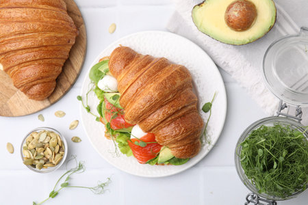 Flat lay composition with tasty croissants and products on white tableの写真素材