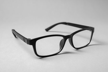 Stylish pair of glasses with black frame on gray backgroundの写真素材