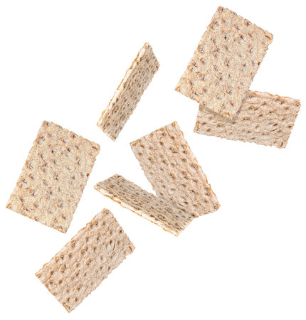 Many tasty crispbreads falling on white backgroundの写真素材