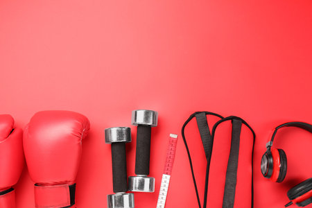 Flat lay composition with dumbbells on red background, space for textの写真素材