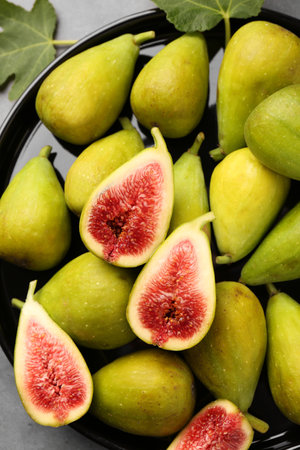 Cut and whole green figs on table, top viewの写真素材
