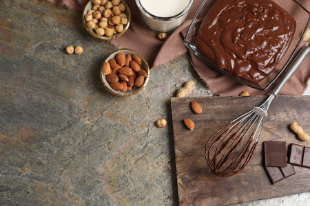 Bowl of chocolate cream, whiskey and ingredients on textured table, flat lay. Space for textの写真素材