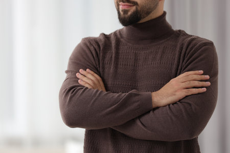 Man in stylish sweater against blurred background, closeupの写真素材