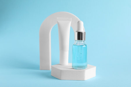 Stylish presentation of cosmetic serum on light blue backgroundの写真素材