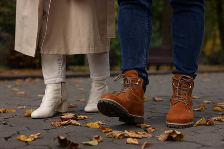 Young couple walking in autumn park, closeupの写真素材