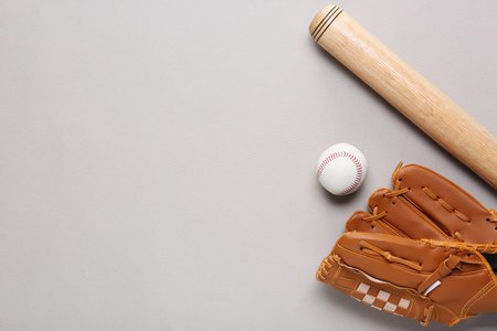 Baseball glove, bat and ball on light gray background, flat lay. Space for textの写真素材