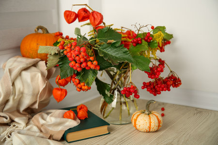 Beautiful autumn composition with different pumpkins and book indoorsの写真素材