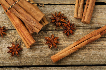 Cinnamon sticks and star anise on wooden table, flat layの写真素材