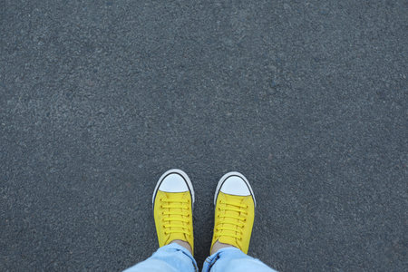 Woman standing on asphalt, top view. Space for textの写真素材