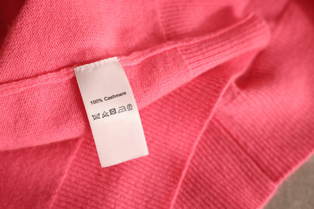 Clothing label on coral garment, closeup viewの写真素材