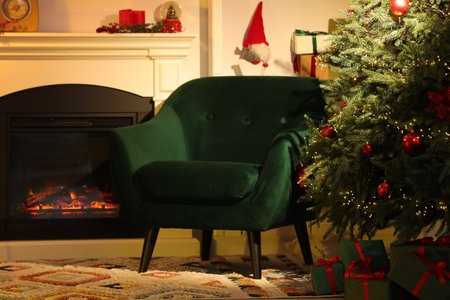 Living room interior with fireplace, armchair and Christmas decorの写真素材