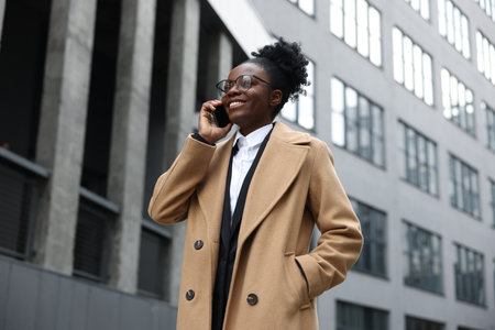 Happy woman talking on smartphone outdoors. Lawyer, businesswoman, accountant or managerの写真素材
