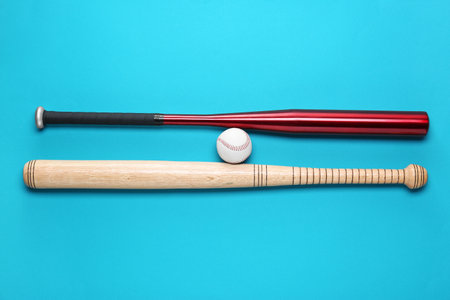 Baseball bats and ball on light blue background, flat layの写真素材