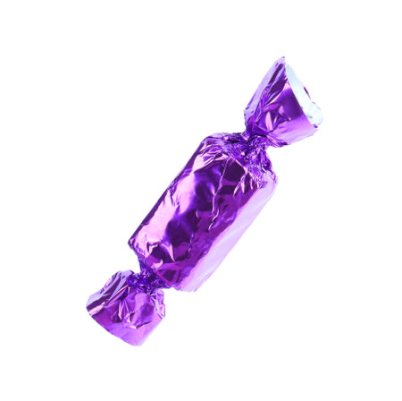 Tasty candy in purple wrapper isolated on whiteの写真素材