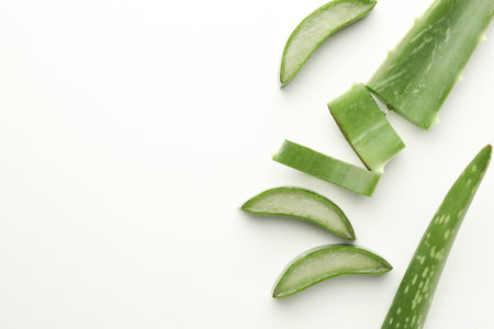 Fresh aloe vera pieces on white background, flat lay. Space for textの写真素材