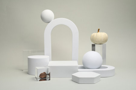 Autumn presentation for product. Geometric figures, pumpkins and acorn on light gray background