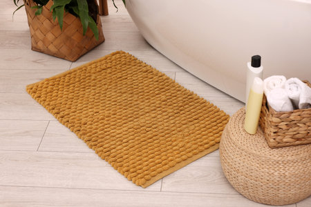 Soft bath mat, towels and cosmetic products in bathroomの写真素材