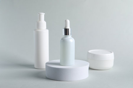 Bottles with cosmetic serums on light gray backgroundの写真素材