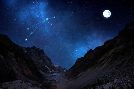 Aries constellation in starry sky over mountains on full moon nightの写真素材