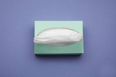 Box of paper tissues on purple background, above viewの写真素材