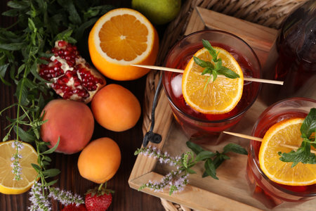 Delicious refreshing sangria, fresh fruits and berries on wooden table, above viewの写真素材