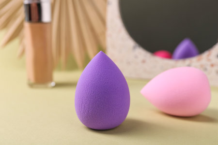 Stylish presentation of makeup sponges on light yellow background, closeupの写真素材