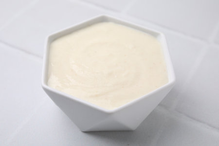 Bowl of delicious semolina pudding on white table, closeupの写真素材