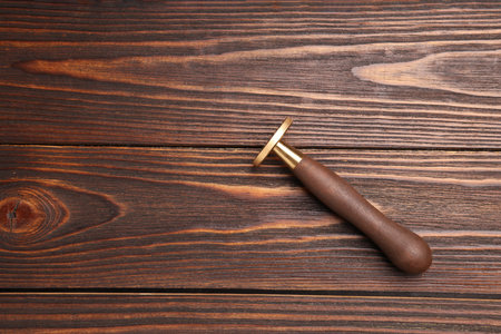 One stamp tool on wooden table, top view. Space for textの写真素材