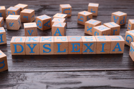 Cubes with word Dyslexia on wooden tableの写真素材
