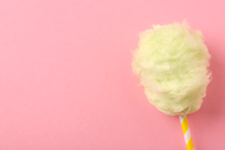 Sweet cotton candy on pink background, top view. Space for textの写真素材