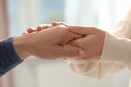 Trust and deal. Man with woman joining hands on blurred background, closeupの写真素材