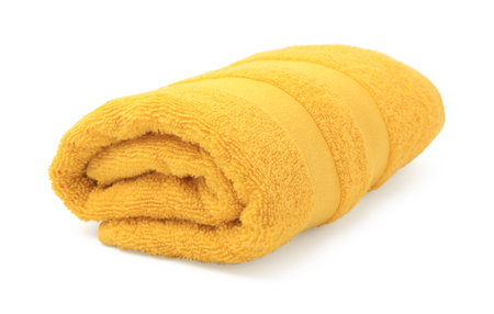 Rolled yellow terry towel isolated on whiteの写真素材