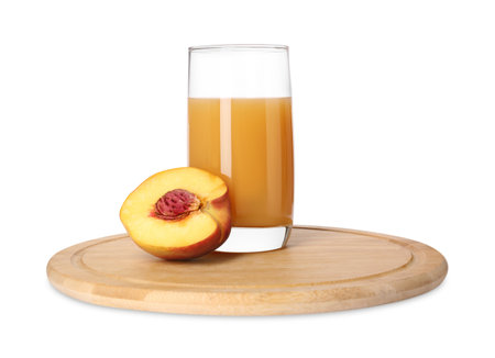 Glass of delicious juice and cut peach isolated on whiteの写真素材