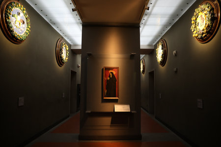 Florence, Italy - February 8, 2024: Famous painting "Saint Monica and Two Children" by Paolo Uccello at Uffizi galleryのeditorial素材