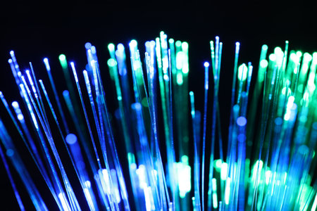 Optical fiber strands transmitting different color lights on black background, closeupの写真素材