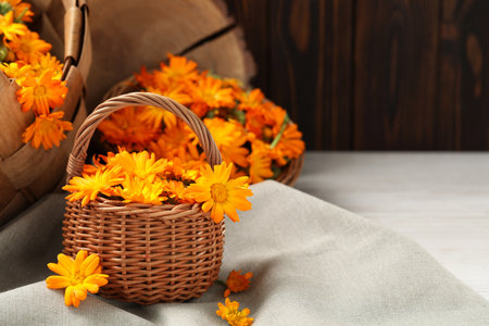 Beautiful fresh calendula flowers on table, space for textの写真素材