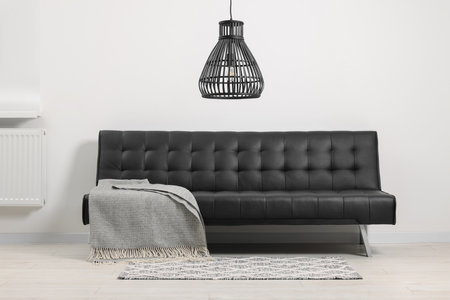 Comfortable sofa with gray blanket in living roomの写真素材